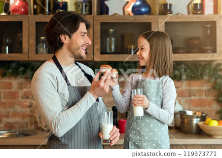 Snacks Time With Dad. Happy Little Girl And Her Father Eating Muffins And Drinking Milk In Kitchen, Free Space Snacks Time With Dad. Happy Little Girl And Her Father Eating Muffins And Drinking Milk In Kitchen, Free Space 119373771