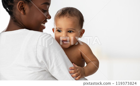 Happiness In A Smile. Portrait of adorable African American baby smiling, young mum holding and hugging her little child, playing together, white background, free copy space, banner, panorama 119373824