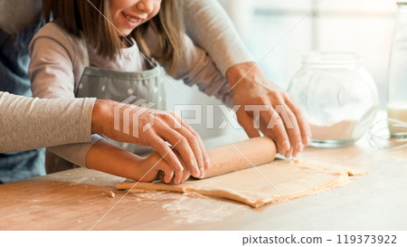 Father Showing His Cute Little Daughter How To Roll Dough For Cookies, Family Baking In Kitchen Together, Cropped Image With Copy Space Father Showing His Cute Little Daughter How To Roll Dough For Cookies, Family Baking In Kitchen Together, Cropped Image With Copy Space 119373922