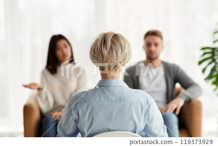 Marital Therapy. Professional Psychologist Sitting Back To Camera During Appointment With Unhappy Couple In Office. Rear View, Selective Focus 119373929