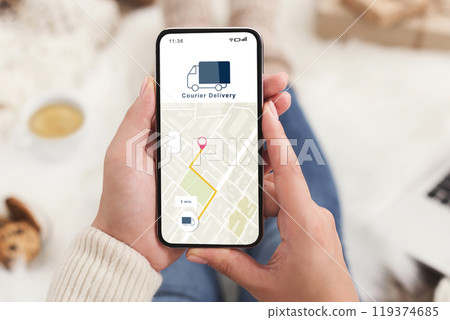 Modern courier delivery at home, shopogolic and online shopping. Hands of lady holding smartphone with mobile app and map to track the order on digital screen on blurred background, collage, cropped Modern courier delivery at home, shopogolic and online shopping. Hands of lady holding smartphone with mobile app and map to track the order on digital screen on blurred background, collage, cropped 119374685