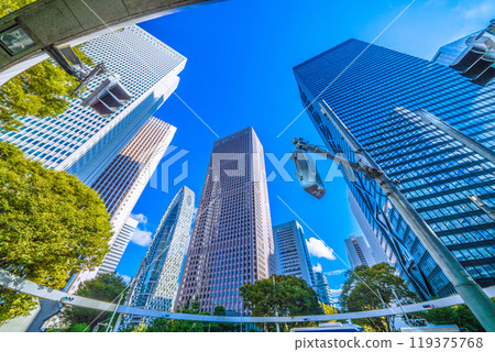 Shinjuku, Tokyo cityscape in Japan. View of Nishi-Shinjuku sign at the intersection behind Shinjuku Police Station and skyscrapers, October 7th 119375768