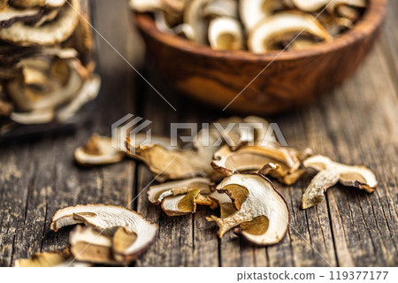 Dried porcini mushrooms. Sliced boletus on wooden table. 119377177