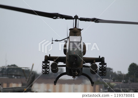 A hovering AH1 Cobra combat helicopter 119378081