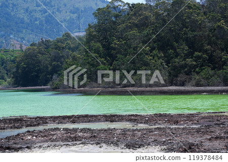 A stunning view of Telaga Warna, a colorful lake in Dieng Plateau, Indonesia. A stunning view of Telaga Warna, a colorful lake in Dieng Plateau, Indonesia. 119378484