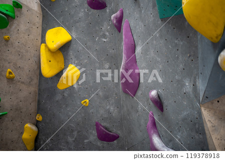 Closeup of colorful climbing holds on artificial 119378918