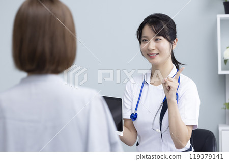 Female healthcare worker and patient 119379141