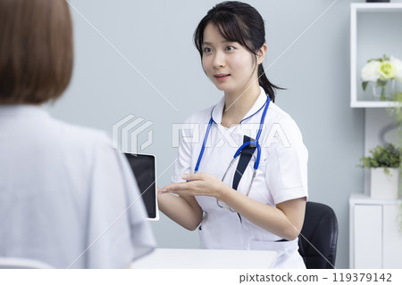 Female healthcare worker and patient Female healthcare worker and patient 119379142