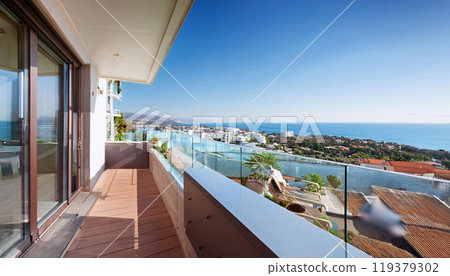 A panoramic view from a balcony overlooking a coastal cityscape 119379302