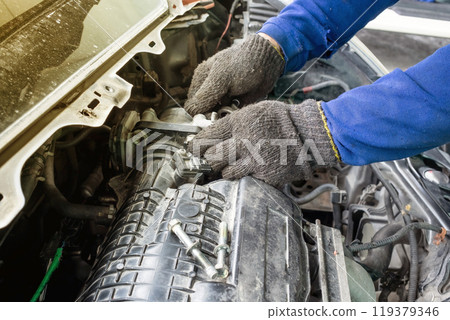 Hands of car mechanic/technician is repairing/checking and fixing 119379346