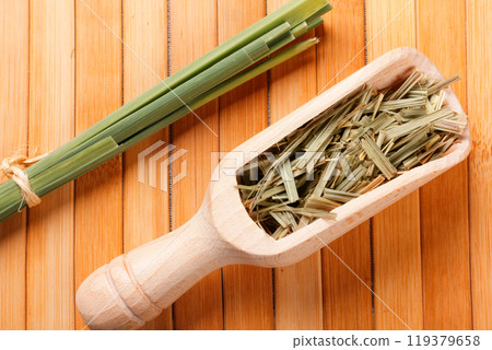 portion of dried organic lemongrass spoon on rustic wooden table 119379658