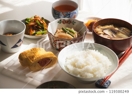 Healthy Japanese home-style set meal. Rice, miso soup, cod roe roll, natto, side dish, pickles Healthy Japanese home-style set meal. Rice, miso soup, cod roe roll, natto, side dish, pickles 119380249