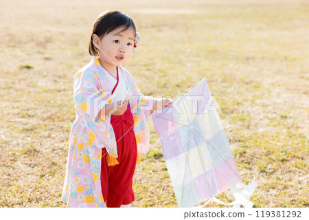 A one-year-old child flying a kite - New Year's play A one-year-old child flying a kite - New Year's play 119381292