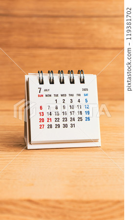 July 2025 calendar on wood background 119381702
