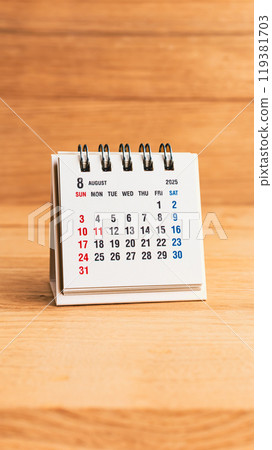 August 2025 calendar on wood background 119381703
