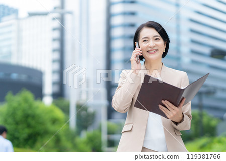 Middle-aged business woman working in an office district 119381766