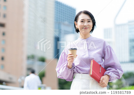 Middle-aged business woman working in an office district Middle-aged business woman working in an office district 119381789