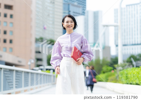 Middle-aged business woman working in an office district 119381790