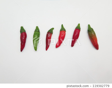 Small fresh chili peppers lined up 119382779