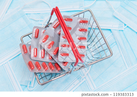 Pills and Capsules in Shopping Basket on the Surgical Masks 119383313