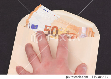 Hand Holds An Orange Paper Envelope with Stack of 50-Euro Banknotes Inside 119383317