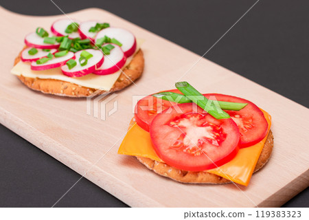 Different Cracker Sandwiches with Tomato, Cucumber, Radish and Cheese Different Cracker Sandwiches with Tomato, Cucumber, Radish and Cheese 119383323