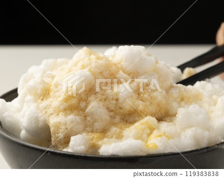 Pick up fluffy egg-topped rice with chopsticks Pick up fluffy egg-topped rice with chopsticks 119383838