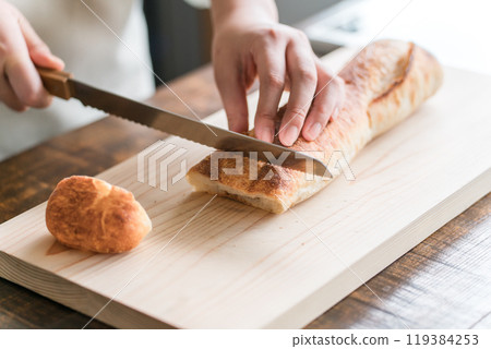 Woman's hands holding French bread Woman's hands holding French bread 119384253