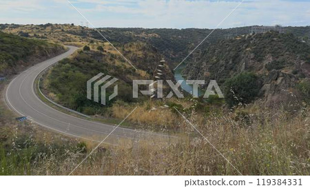 Majestic Canyon with Scenic Road by River Duero Majestic Canyon with Scenic Road by River Duero 119384331