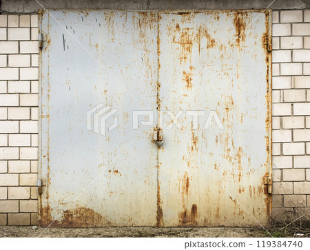 old metal door to the car garage old metal door to the car garage 119384740