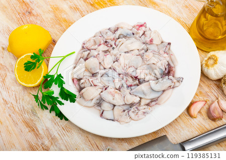Raw baby squid with condiments ready for preparation 119385131