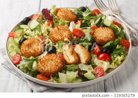 Seasonal salad of fried cheese with tomatoes, cucumber, olives and mixed lettuce close-up in a plate. Horizontal Seasonal salad of fried cheese with tomatoes, cucumber, olives and mixed lettuce close-up in a plate. Horizontal 119385279