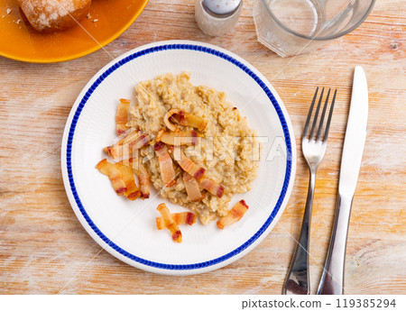 Oatmeal porridge served with fried lard Oatmeal porridge served with fried lard 119385294