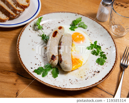 Delicious hearty breakfast with scrambled eggs and sausage closeup Delicious hearty breakfast with scrambled eggs and sausage closeup 119385314