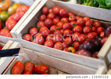 Pile of tomatoes lie on counter in shop Pile of tomatoes lie on counter in shop 119385318