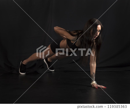 Beautiful athletic girl on a dark background 119385363