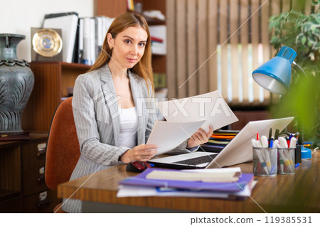 Female secretary doing paperwork in office 119385531