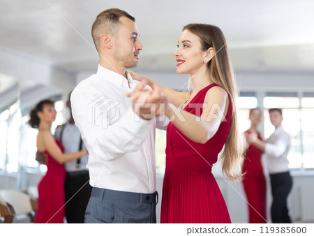 Young man and girl dancing waltz in couple during lesson at studio Young man and girl dancing waltz in couple during lesson at studio 119385600