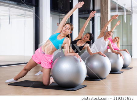 Group of people doing stretching exercises 119385653