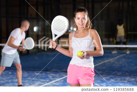 Young beautiful woman posing on padel court Young beautiful woman posing on padel court 119385688
