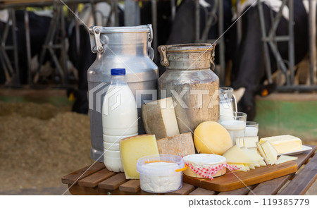 Fresh natural farm dairy products on table in cowshed 119385779