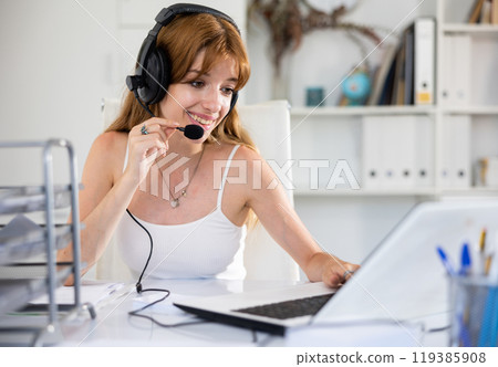 Attractive young woman working in call center 119385908