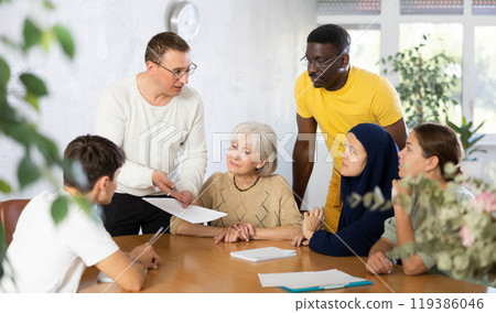 Group of multinational people making notes at table 119386046