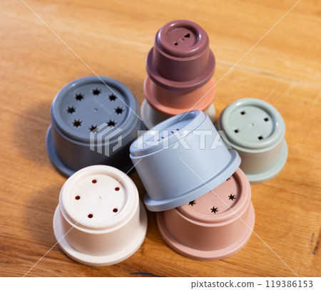 Childrens toy plastic cup pyramid made of multicolored elements Childrens toy plastic cup pyramid made of multicolored elements 119386153