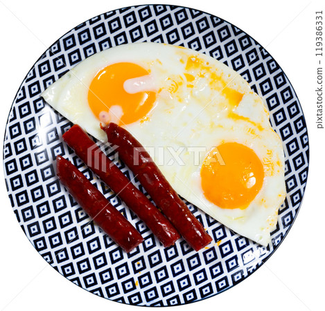 Fried eggs served with chistorra sausages Fried eggs served with chistorra sausages 119386331