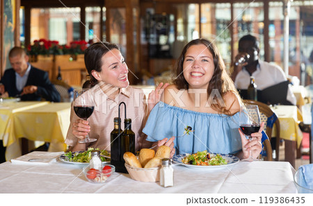 Couple enjoying dinner with wine at restaurant 119386435