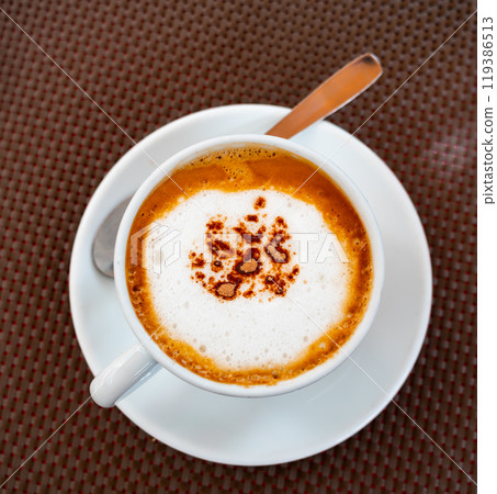 Cup of delicious hot cappuccino coffee with foam Cup of delicious hot cappuccino coffee with foam 119386513