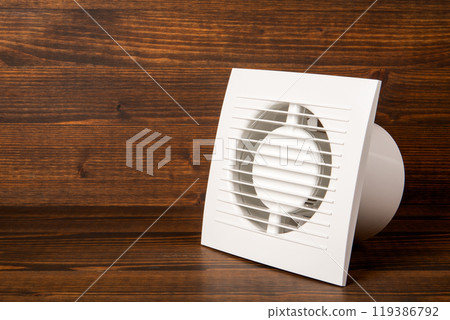 Equipment for removing dirty air from the room and bathroom of the house. Wood texture background Equipment for removing dirty air from the room and bathroom of the house. Wood texture background 119386792