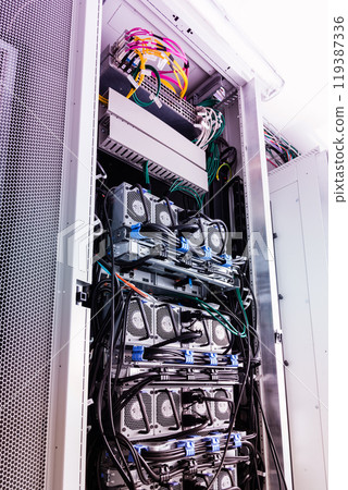 Racks filled with computer hardware inside internet datacenter 119387336