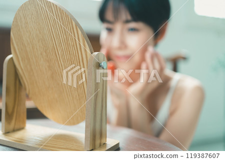 Woman looking in the mirror Woman looking in the mirror 119387607